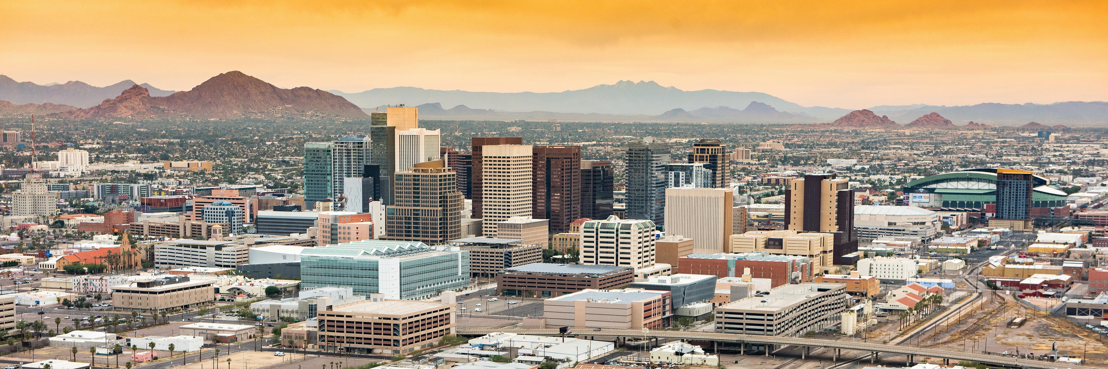 Phoenix, Arizona skyline with mountains in the background at dusk
